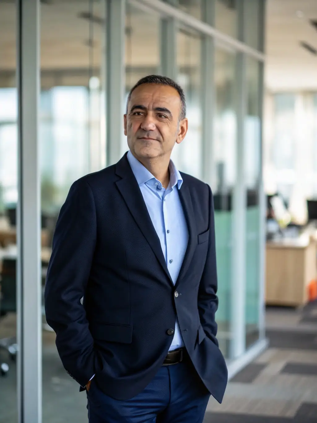 A professional headshot of a GetCenter product manager, smiling confidently in a modern office setting, symbolizing the company's commitment to innovation.