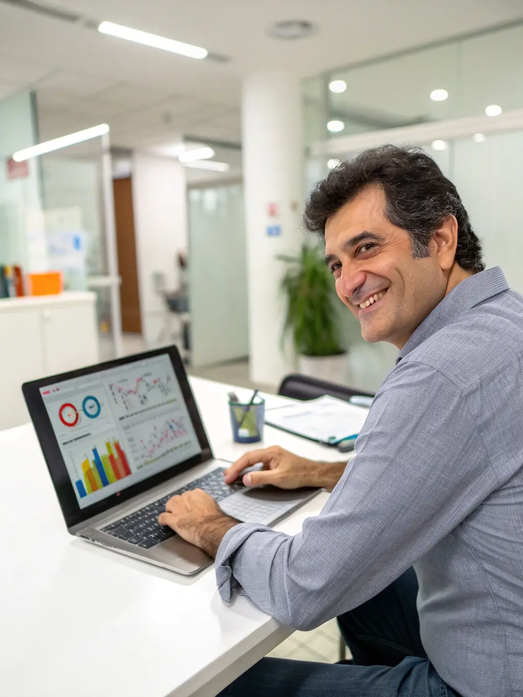 A professional headshot of a financial analyst smiling confidently, representing Mercury's commitment to expert financial solutions.